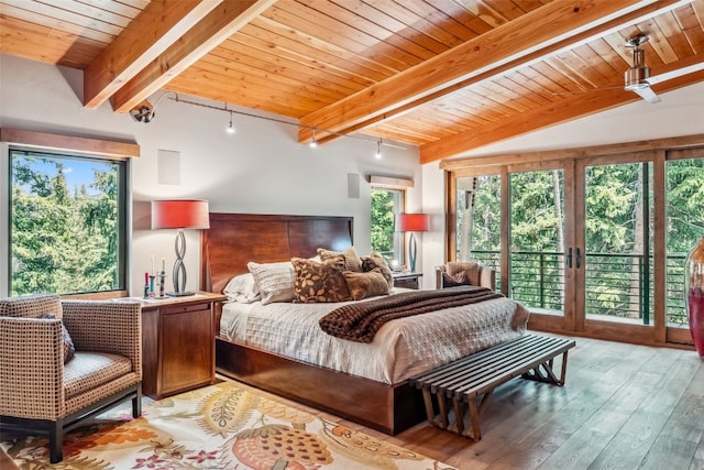 bedroom featuring vaulted ceiling with beams, light wood-type flooring, access to outside, and multiple windows