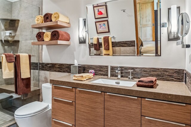 bathroom featuring vanity, toilet, and walk in shower