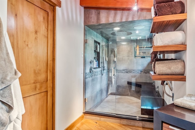 bathroom with hardwood / wood-style floors and walk in shower