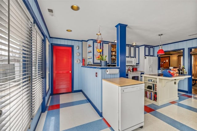 kitchen featuring visible vents, baseboards, decorative light fixtures, light floors, and white appliances