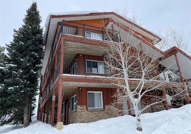 view of snow covered exterior featuring a balcony