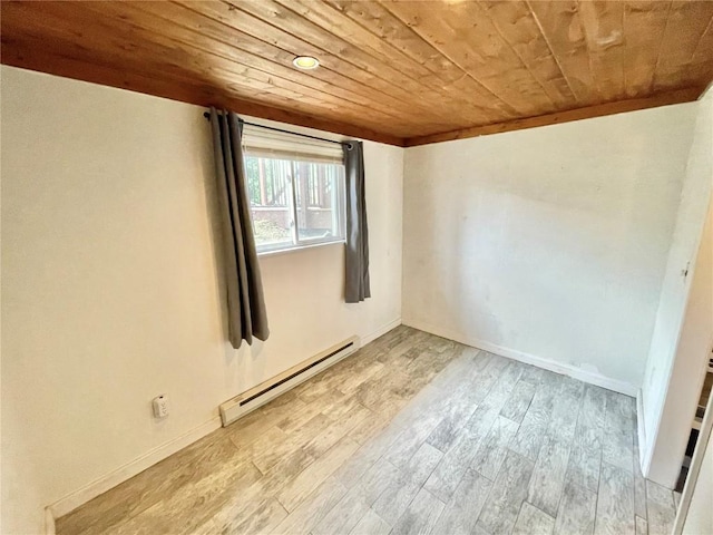 empty room with wooden ceiling, baseboard heating, and light hardwood / wood-style floors