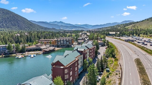 wooden deck with a water and mountain view