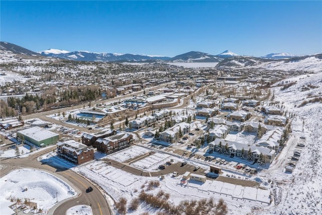 snowy aerial view featuring a mountain view