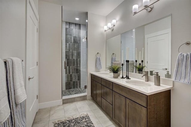 full bath with a sink, double vanity, a stall shower, and tile patterned floors