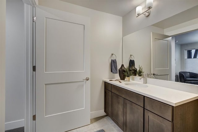 bathroom featuring vanity, baseboards, and tile patterned flooring