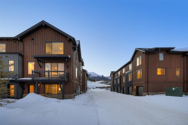 view of snow covered rear of property