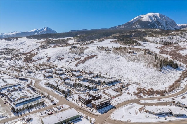 snowy aerial view featuring a mountain view