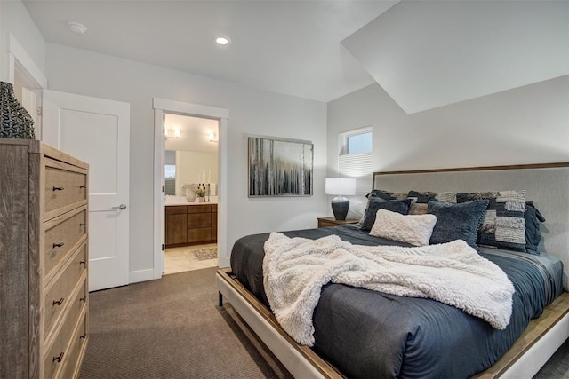 bedroom featuring ensuite bathroom, recessed lighting, and dark carpet