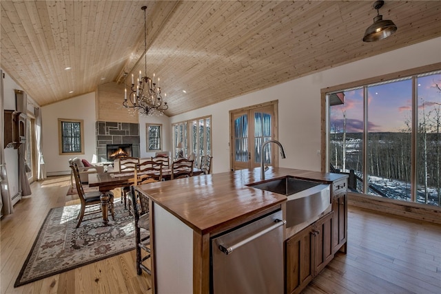 kitchen with sink, decorative light fixtures, wooden ceiling, stainless steel dishwasher, and an island with sink