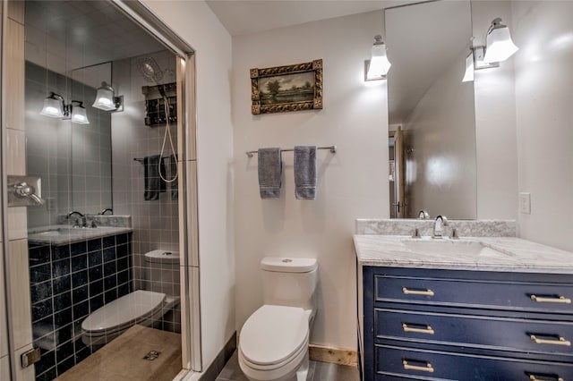 bathroom featuring vanity, an enclosed shower, and toilet