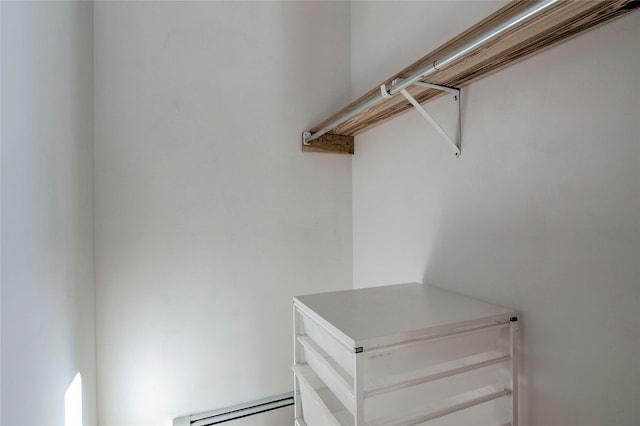 walk in closet with a baseboard radiator