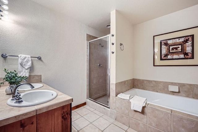 bathroom featuring tile patterned flooring, vanity, and independent shower and bath