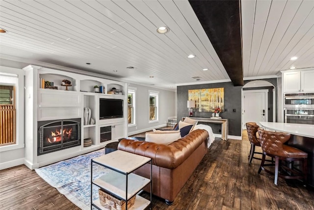 living room with built in shelves, beam ceiling, wood ceiling, and dark wood-type flooring