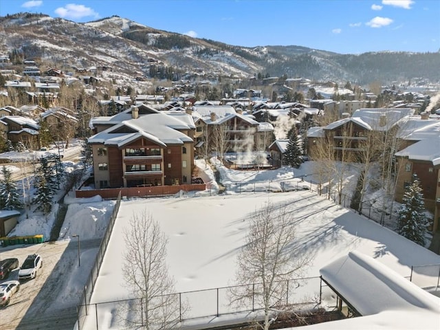 snowy aerial view with a mountain view