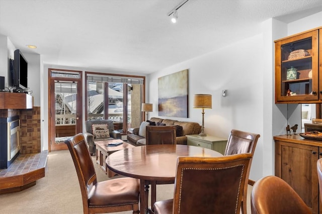 carpeted dining room with track lighting