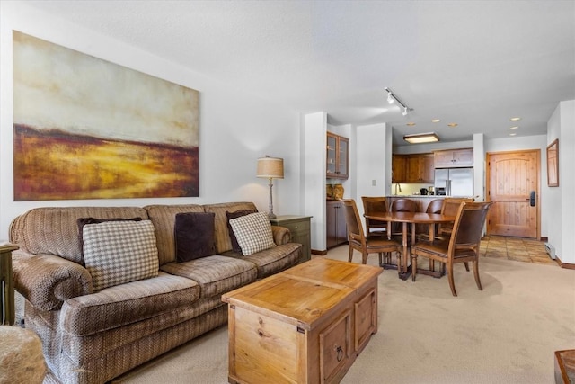 carpeted living room with track lighting