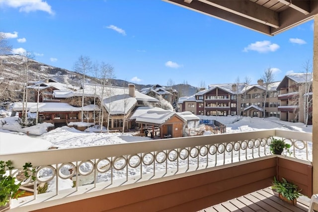 view of snow covered back of property