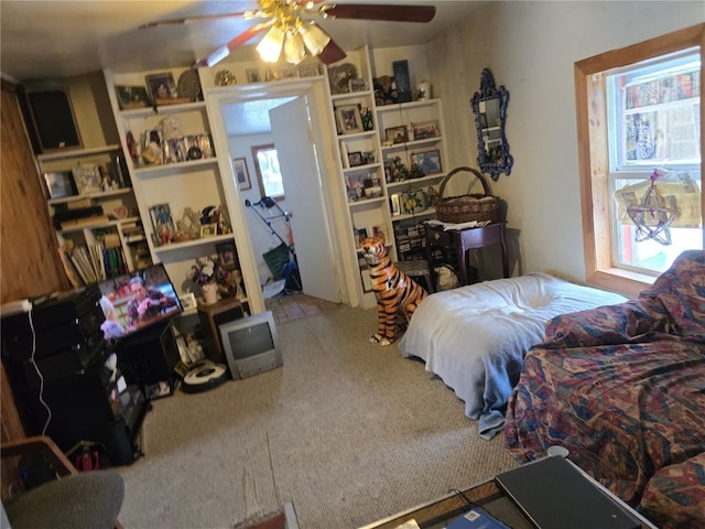 carpeted bedroom with multiple windows and ceiling fan