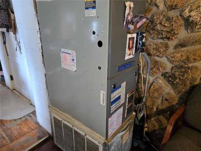 utility room featuring heating unit