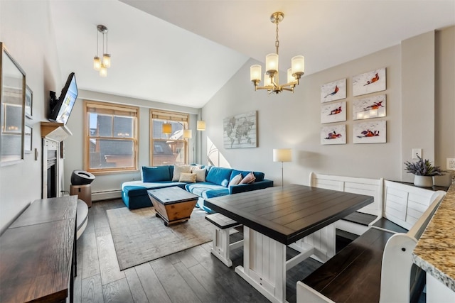 dining area with a notable chandelier, baseboard heating, dark wood-type flooring, and vaulted ceiling