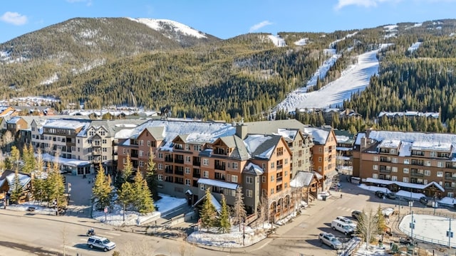 snowy aerial view with a mountain view