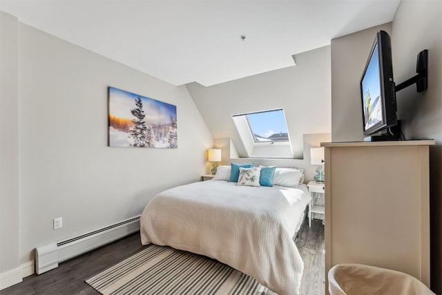 bedroom featuring lofted ceiling with skylight, baseboard heating, baseboards, and wood finished floors