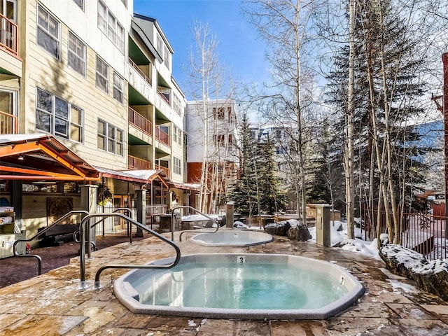 view of swimming pool with a community hot tub