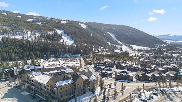 snowy aerial view with a mountain view