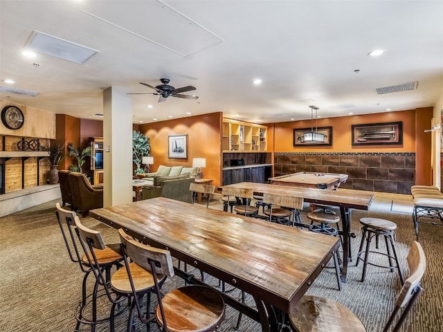 carpeted dining space featuring recessed lighting, visible vents, attic access, and ceiling fan