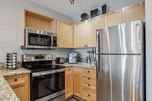 kitchen with light brown cabinetry, open shelves, stainless steel appliances, and light stone countertops