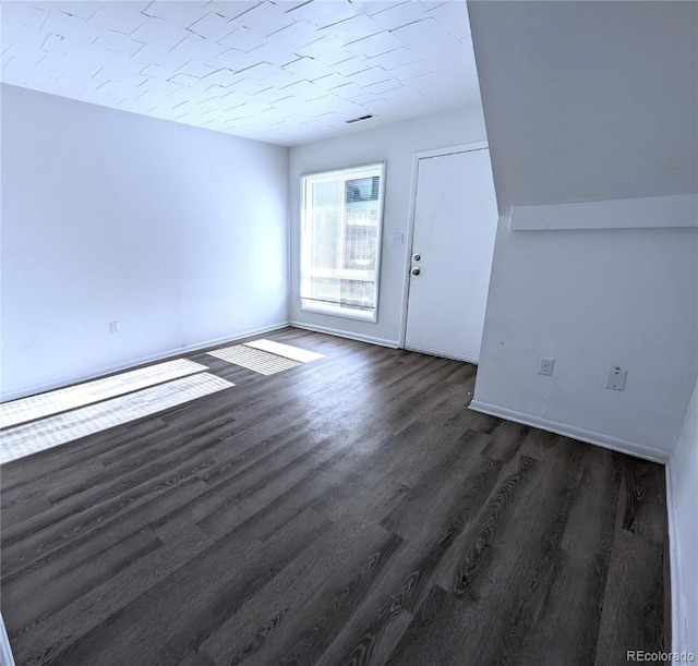 unfurnished room with dark hardwood / wood-style floors