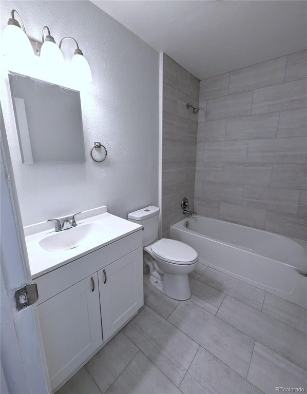 full bathroom featuring vanity, toilet, and tiled shower / bath