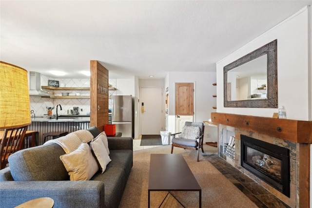 living room with sink and a tile fireplace