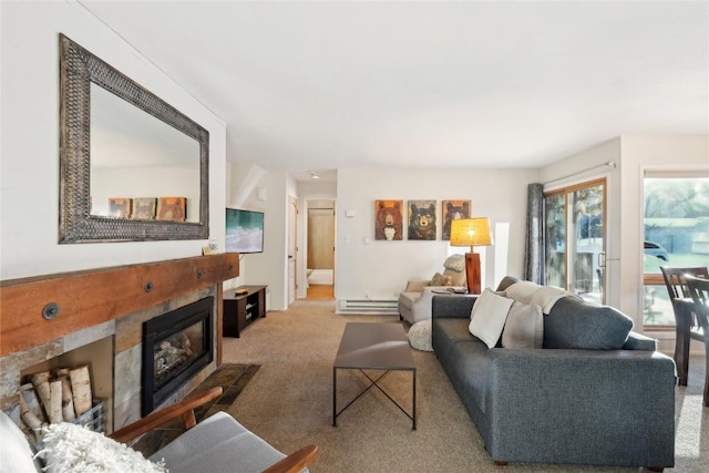 living room with baseboard heating, a tile fireplace, and light carpet