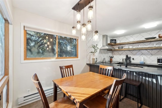 dining space with sink and a baseboard radiator