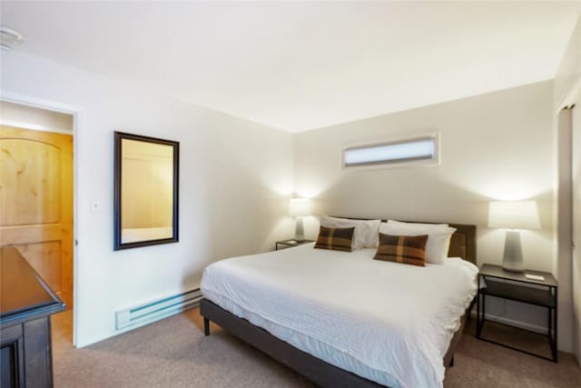 bedroom featuring baseboard heating and light colored carpet