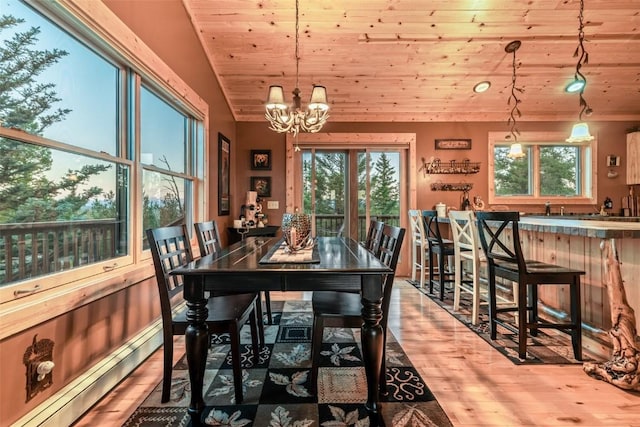 dining area featuring a baseboard radiator, wooden ceiling, vaulted ceiling, and an inviting chandelier