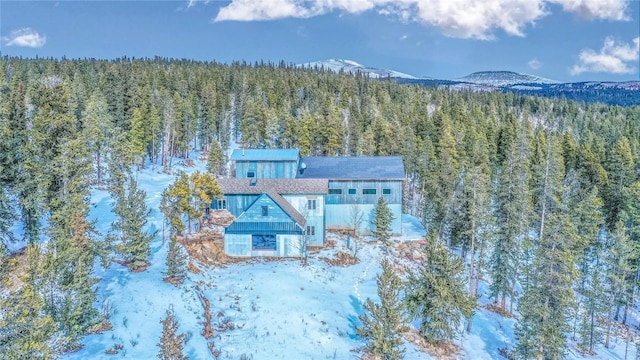 snowy aerial view featuring a mountain view