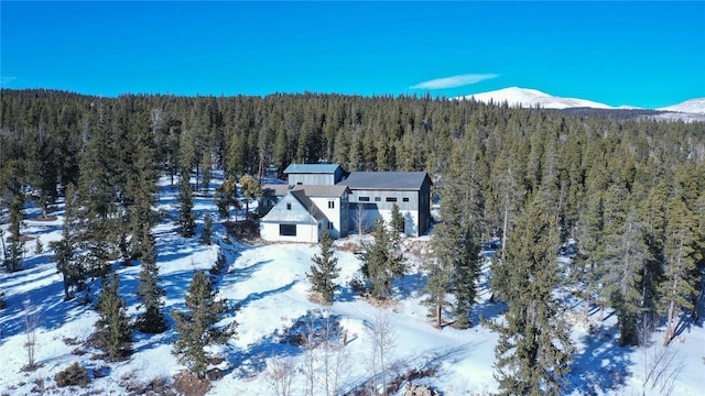 snowy aerial view with a mountain view