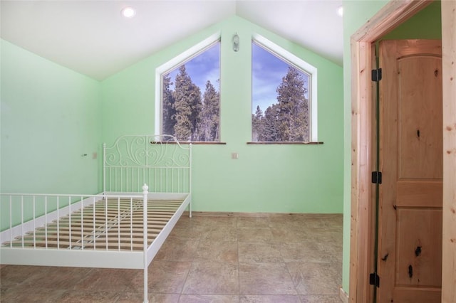 unfurnished bedroom with vaulted ceiling