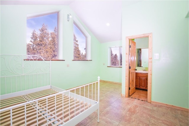 interior space with ensuite bathroom and vaulted ceiling