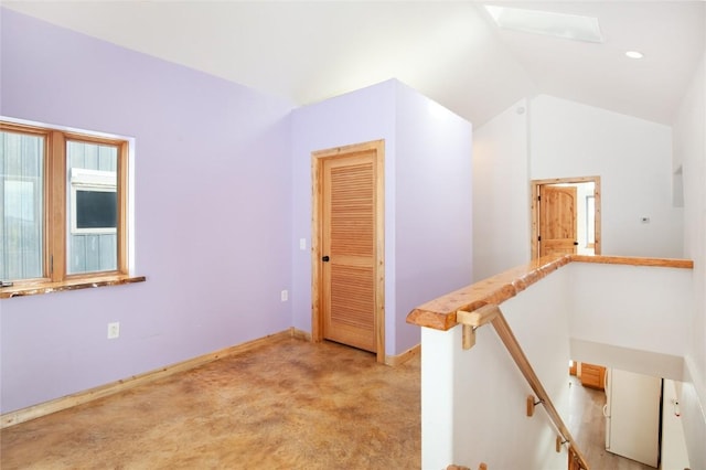 stairs featuring lofted ceiling with skylight