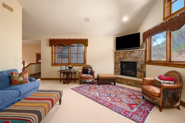 living room featuring a fireplace, carpet floors, and lofted ceiling