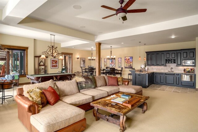 carpeted living room with sink, ceiling fan, and pool table