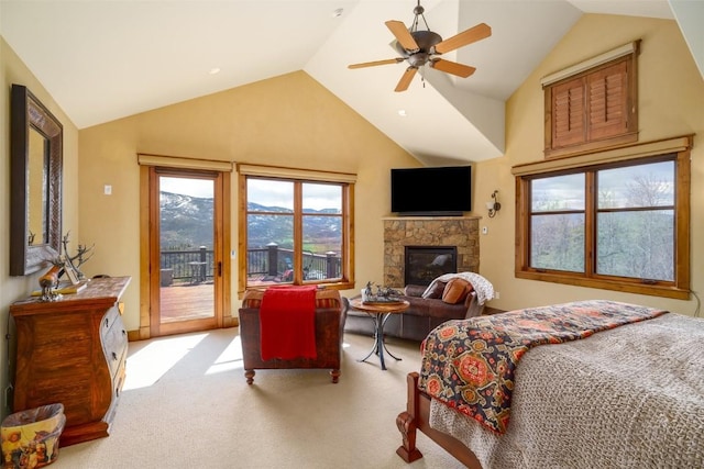 bedroom with lofted ceiling, light carpet, access to outside, ceiling fan, and a fireplace