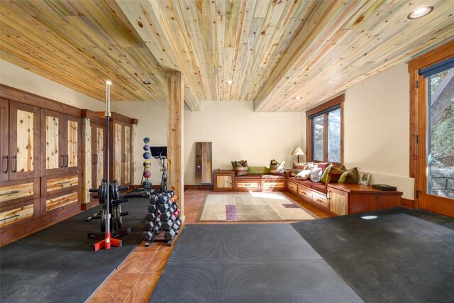 workout room featuring tile patterned flooring, plenty of natural light, and wooden ceiling