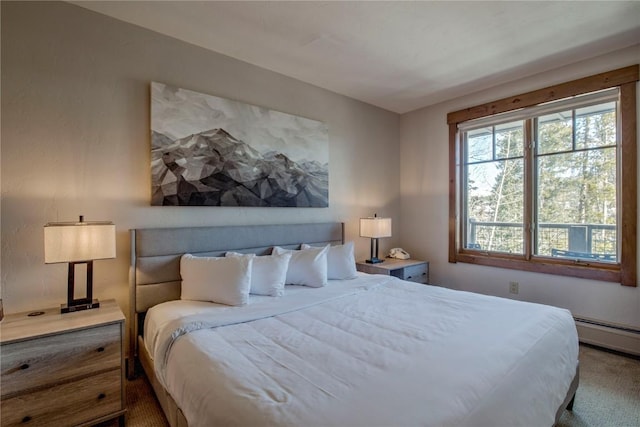 bedroom with carpet floors and baseboard heating