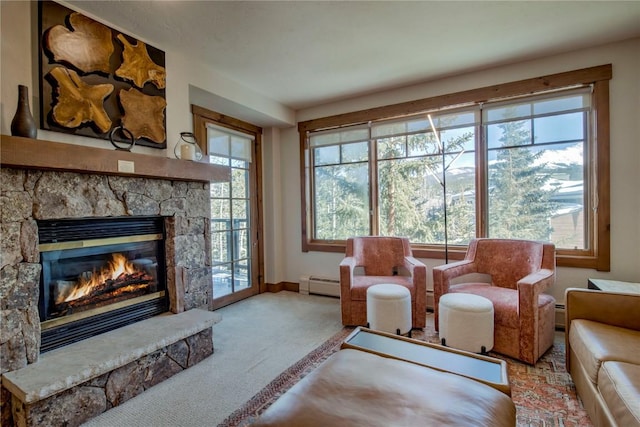 sitting room featuring a wealth of natural light, a stone fireplace, light colored carpet, and baseboard heating