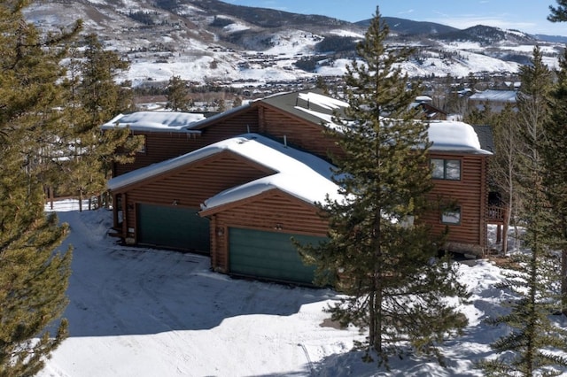 exterior space with a garage and a mountain view